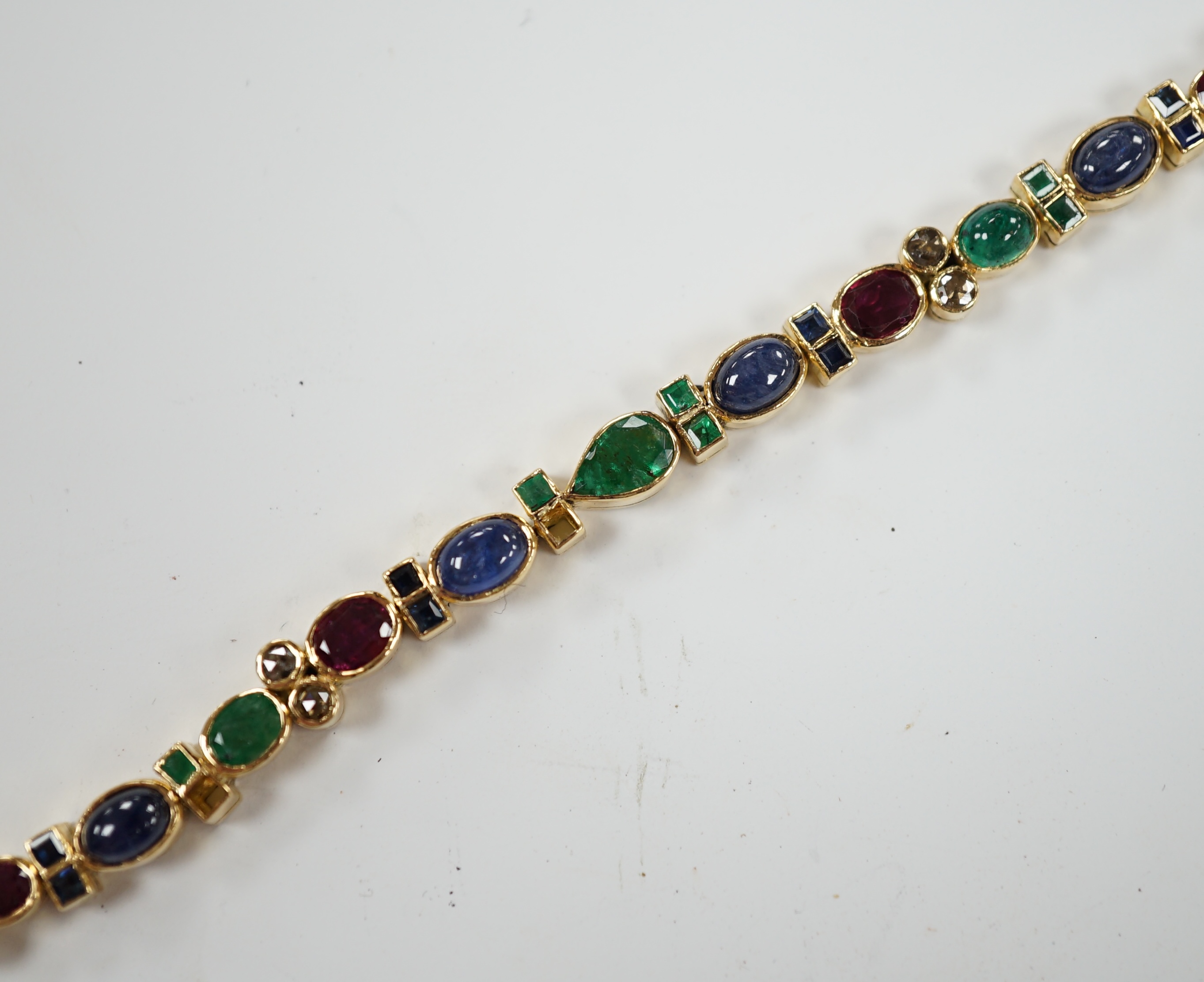A yellow metal, diamond, ruby, sapphire and emerald cluster set line bracelet, 18.6cm, gross weight 18.3 grams.